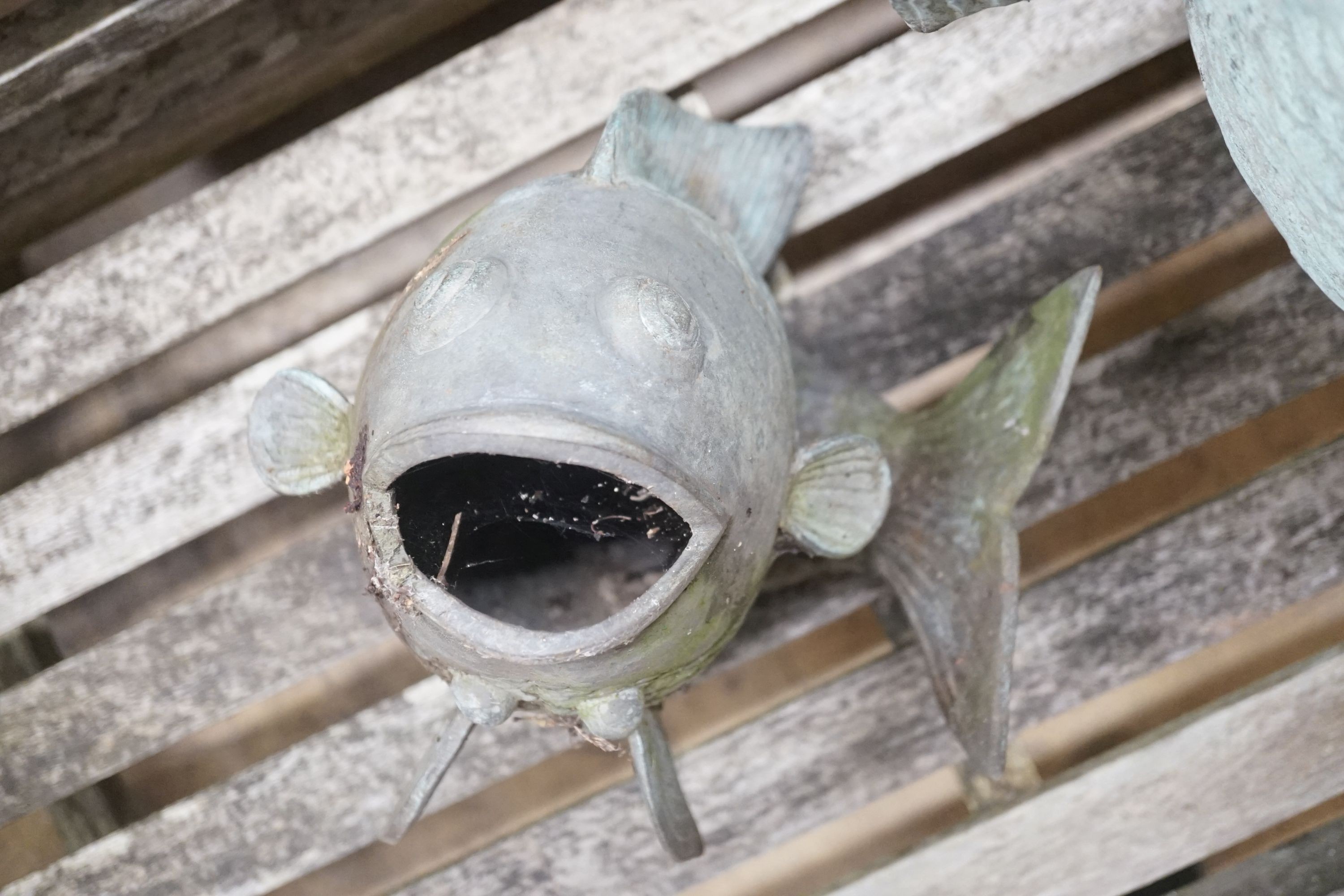 Three cast metal carp garden ornaments, largest 60cm height 46cm